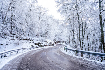Beautiful road winter landscape with snow on the trees
