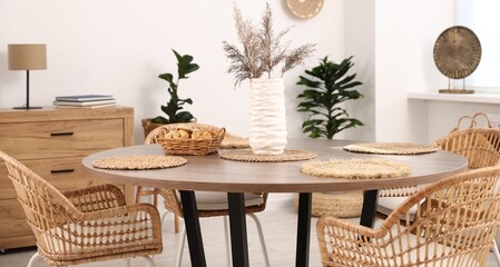 Stylish table with chairs and decor in dining room. Interior design