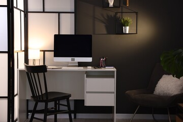 Desk with computer, stationery and glasses at home office. Interior design