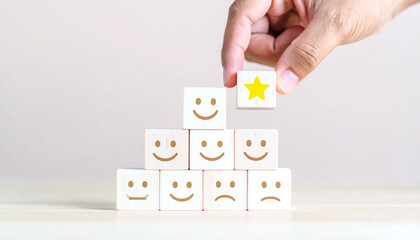 Hand Topping Pyramid of Smiley Blocks with Golden Star