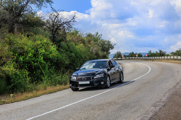 Car moves along a winding mountain road