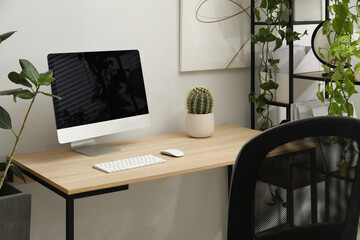 Fototapeta premium Biophilic interior design. Stylish workplace with computer and houseplants in office