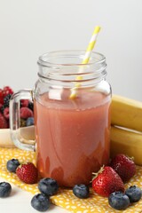 Superfood. Healthy drink in mason jar and ingredients on white wooden table against light grey background, closeup