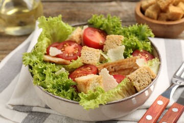 Delicious salad with croutons served on table, closeup
