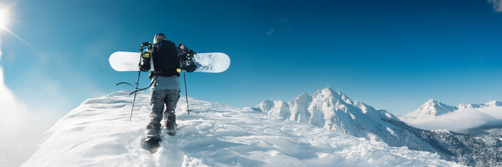Snowboarder on Mountain Peak Wide Banner with Copy Space
