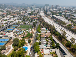 Glendale, CA, LA County, August 14, 2025: Aerial View of Glendale CA around Fremont Park with Glendale Downtown, Buildings, Streets, Homes, Apartments, Mountain, and 134 Freeway
