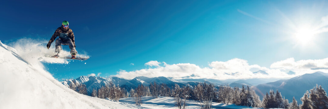 Snowboarder Jumping in Mountain Wide Banner with Copy Space