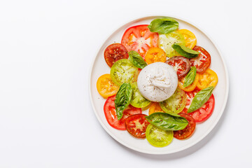 Fresh burrata served on slices of colorful tomatoes