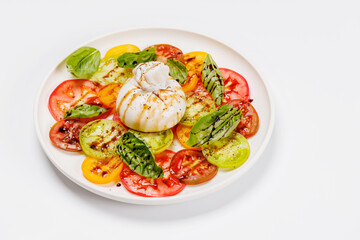 Fresh burrata served on slices of colorful tomatoes