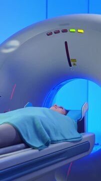 Women patient on CT MRI scanner. Woman moving on computed tomography or magnetic resonance imaging machine in diagnostic clinic. Video computed tomography CT scan process for examination of spine.
