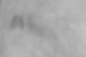 Gray Concrete Wall Irregular Texture. Wet Plaster Surface. Rough Painted Textured Surface. Dark Gray Concrete Backgroud. Close up. Plaster Wall with Visible Irregular Stained Surface. 