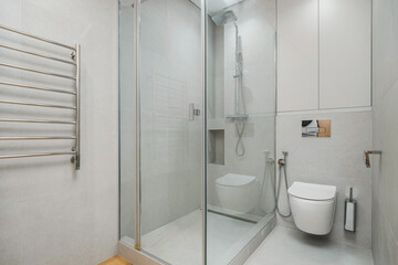Modern bathroom design featuring glass shower enclosure and sleek fixtures