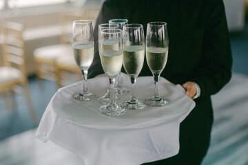 Elegant champagne service at a celebration venue during a joyous event in a well-lit setting