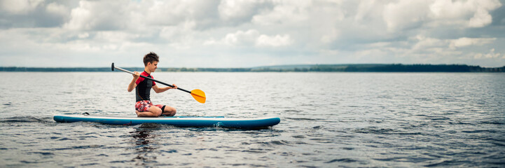 Paddleboarding on Calm Waters Wide Banner