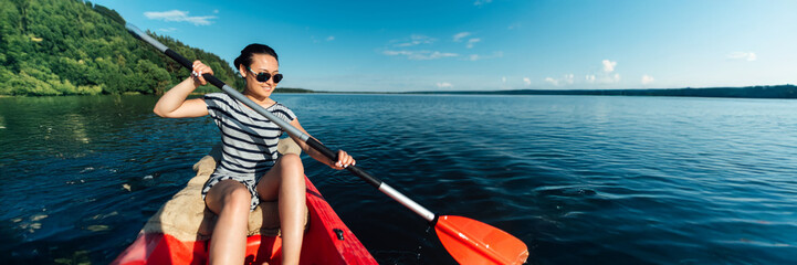 Woman Kayaking on Lake - Wide Banner with Copy Space