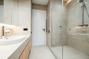 Modern bathroom design featuring minimalist aesthetic with shower and sink from an elegant home