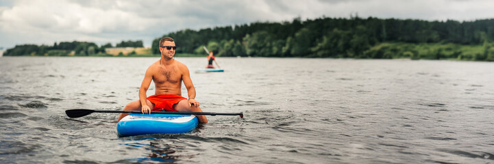 Man on Paddleboard with Copy Space Wide Banner
