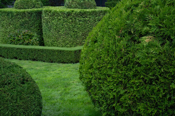 A park with landscaping and bushes of various shapes, a garden