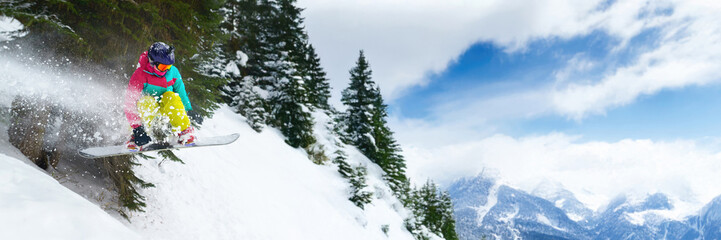 Snowboarder Jumping in a Mountain Landscape Wide Banner