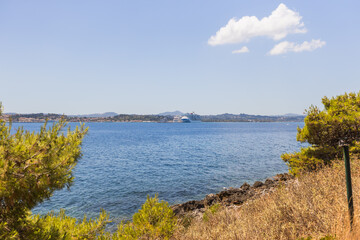 Historic Vido island coastline, known as Blue Tomb where Serbian soldiers were buried at sea during World War I, featuring pristine turquoise waters and memorial significance in Greek waters.