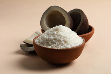 Coconut Powder in orange bowl with dry pieces beside