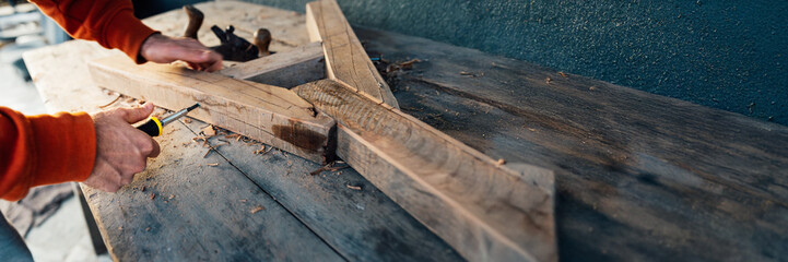 Carpenter Working on Wood with Tools Wide Banner