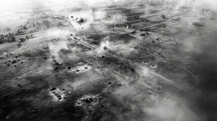 Aerial view of a battlefield in black and white, showing smoke and destruction in a rural area