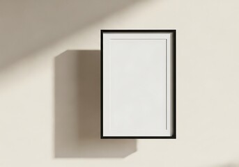 Elegant blank picture frame with soft shadow on textured wall, perfect for modern decor mockups.