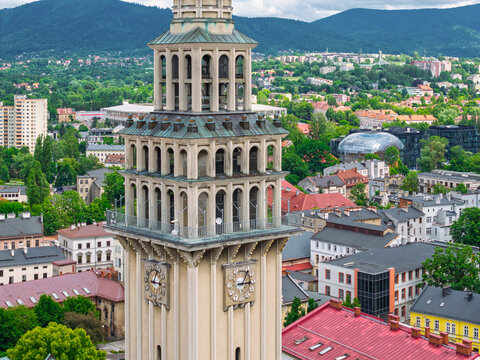 Aerial view of historic town square in Bielsko-Biała, Poland with colorful buildings and mountains in the background.