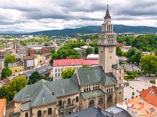 Aerial view of historic town square in Bielsko-Biała, Poland with colorful buildings and mountains in the background.