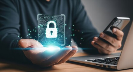 Digital security concept with glowing padlock hologram projected from open palm near smartphone and laptop