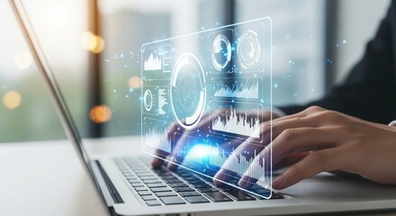 Close up of hands typing on a laptop with a futuristic holographic interface displaying data and charts