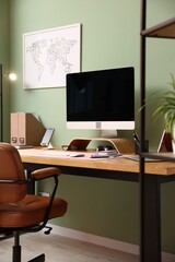 Stylish workplace with modern computer and stationery on wooden desk indoors