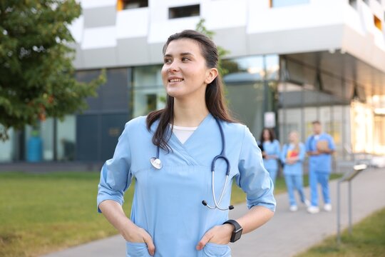 Medical student in uniform with stethoscope outdoors, selective focus - Powered by Adobe
