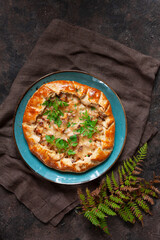 Homemade savory open pie galette with fresh forest edible mushrooms golden chanterelle