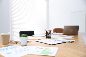 Stylish workplace with stationery and laptop in office, selective focus