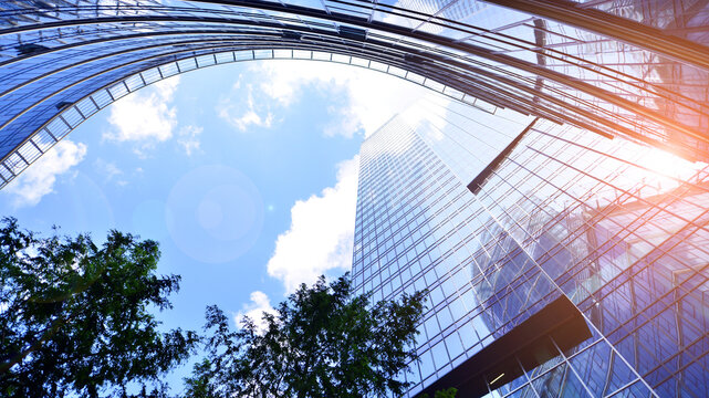 Sustainable glass office building with trees for reducing carbon dioxide. Eco-friendly building in modern city. Office with green environment. Corporate building reduce CO2.