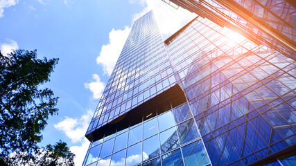 Sustainable glass office building with trees for reducing carbon dioxide. Eco-friendly building in...