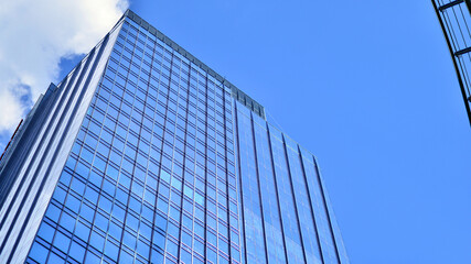 Obraz premium Modern sustainable glass office buildings. Exterior view of corporate headquarters glass buildings architecture.Glass windows in energy-efficient buildings. Financial business center buildings. 