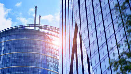 Sustainable glass office building with trees for reducing carbon dioxide. Eco-friendly building in...
