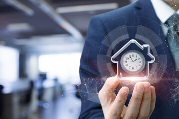 Business professional holds clock and house symbol
