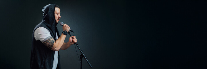 Singer with Microphone on Dark Background, Wide Banner