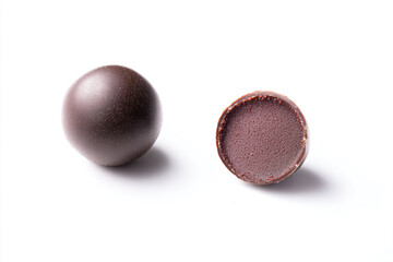 a chocolate egg and a chocolate egg on a white surface
