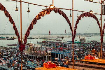 Tourists observing Ganga Aarti ceremony from boats in Varanasi