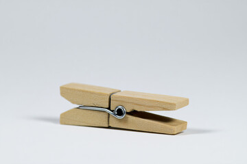 a wooden peg with a metal hook on a white background