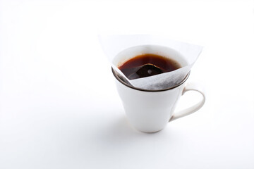 a cup of coffee with a tea bag in it