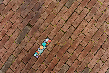 Colorful Mosaic in brown Brick Pavement