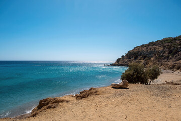 Rocky shoreline with rugged cliffs and calm blue sea on Gavdos Island, Greece.