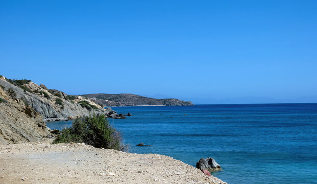 Rocky shoreline with rugged cliffs and calm blue sea on Gavdos Island, Greece. - Powered by Adobe