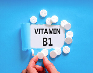 Vitamin B1 symbol. Concept words Vitamin B1 on beautiful white paper. White pills tablets. Doctor's...